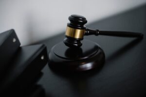 Close-up of a wooden gavel on a desk, symbolizing justice and legal authority.